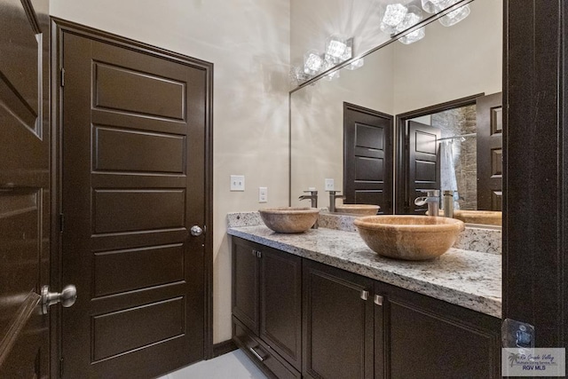 bathroom with a sink and double vanity
