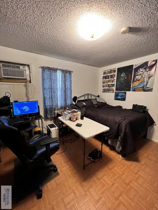 bedroom featuring light parquet floors, a textured ceiling, and a wall mounted AC