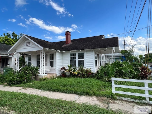 view of front of home with a front yard and a porch