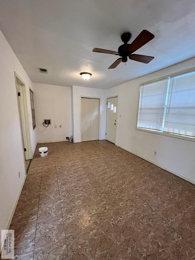 unfurnished room with ceiling fan