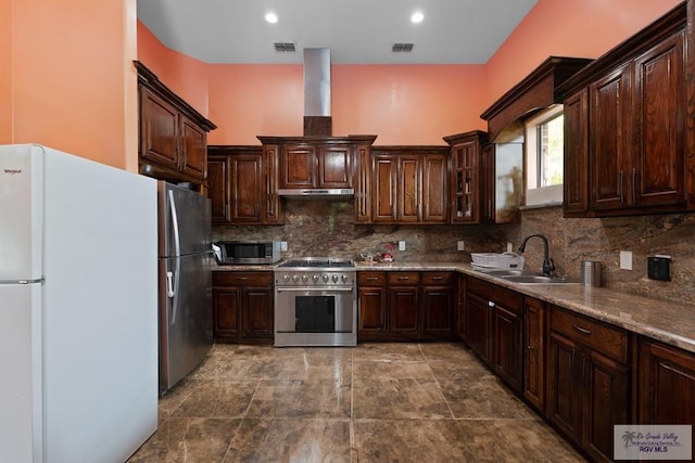 kitchen with decorative backsplash, appliances with stainless steel finishes, dark brown cabinets, and sink