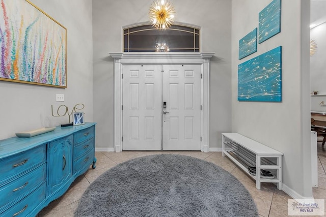 entrance foyer featuring light tile patterned floors and a chandelier