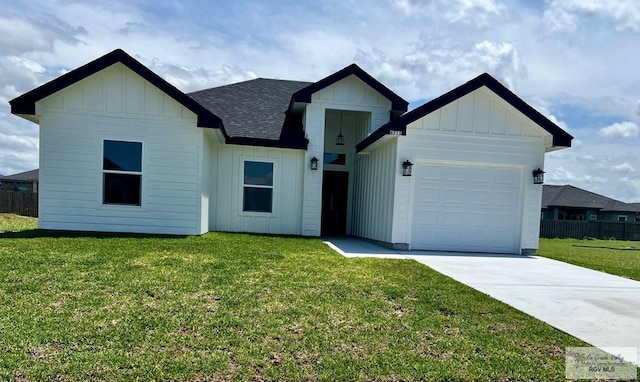 8713 Swan Lake Dr, Harlingen, TX 78552 - view of front facade featuring board and batten siding, a garage, concrete driveway, and roof with shingles