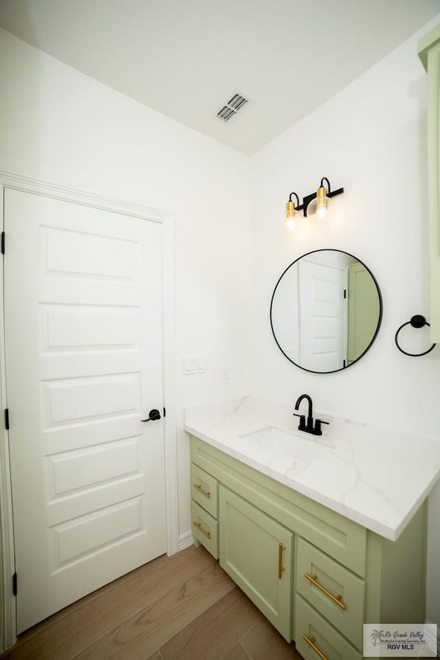 8713 Swan Lake Dr, Harlingen, TX 78552 - bathroom with wood finished floors and vanity
