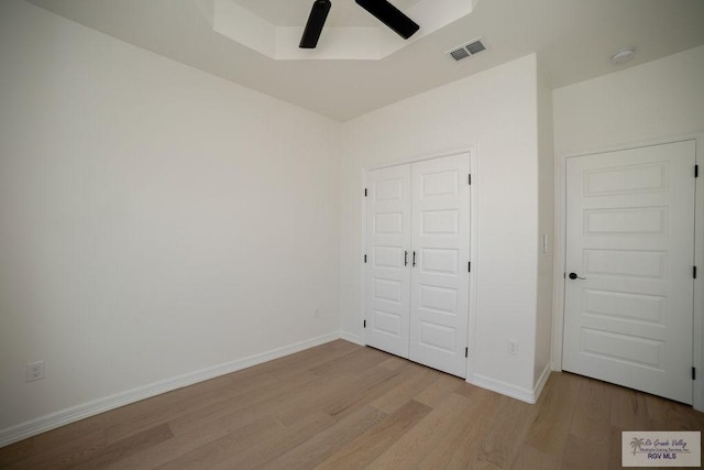 8713 Swan Lake Dr, Harlingen, TX 78552 - unfurnished bedroom featuring wood finished floors, a closet, baseboards, and ceiling fan