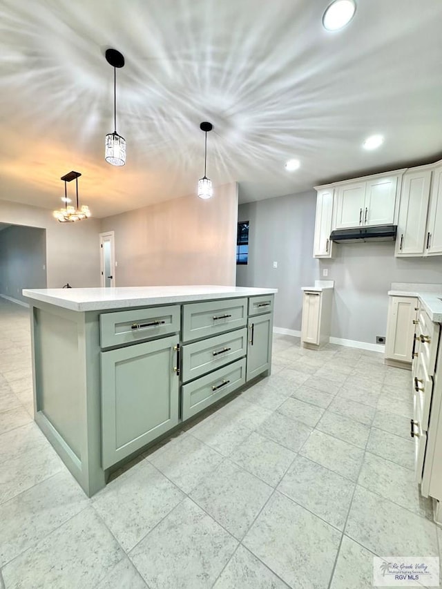 1214 W Monroe Ave, Harlingen, TX 78550 - kitchen featuring green cabinetry, baseboards, recessed lighting, hanging light fixtures, and light countertops