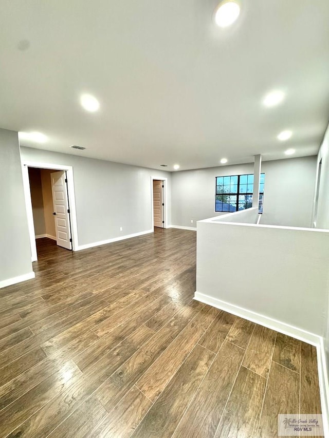 1214 W Monroe Ave, Harlingen, TX 78550 - spare room featuring dark wood-style flooring, baseboards, and recessed lighting