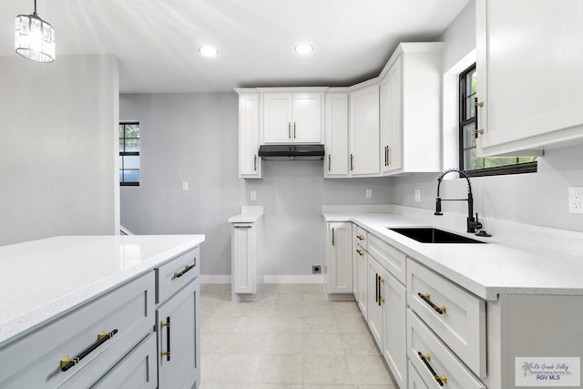 1214 W Monroe Ave, Harlingen, TX 78550 - kitchen with a sink, light countertops, white cabinets, recessed lighting, and pendant lighting