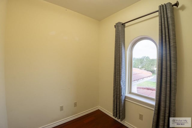 empty room featuring dark wood-type flooring