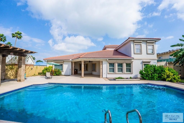 view of swimming pool featuring ceiling fan and a patio