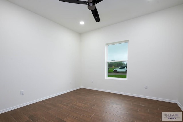 unfurnished room with ceiling fan and dark wood-type flooring