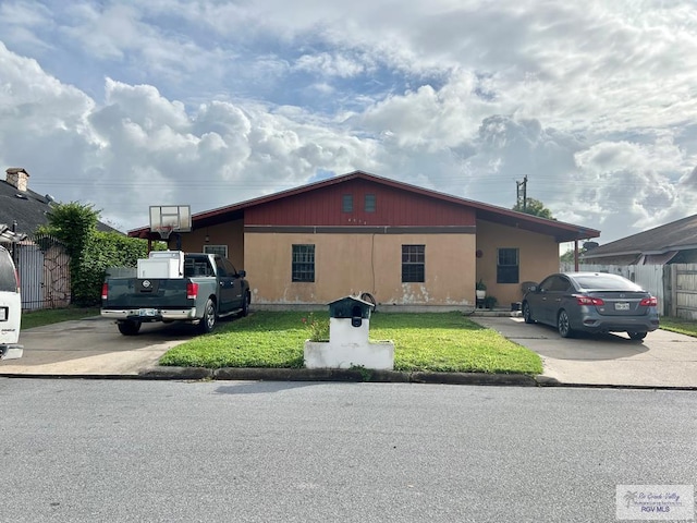 exterior space featuring a carport and a front yard