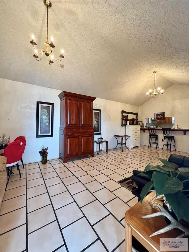 tiled living room with vaulted ceiling, a textured ceiling, and an inviting chandelier