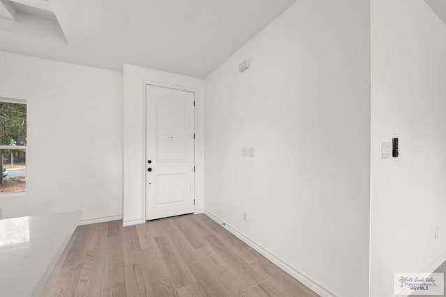 interior space with light wood-style floors and baseboards