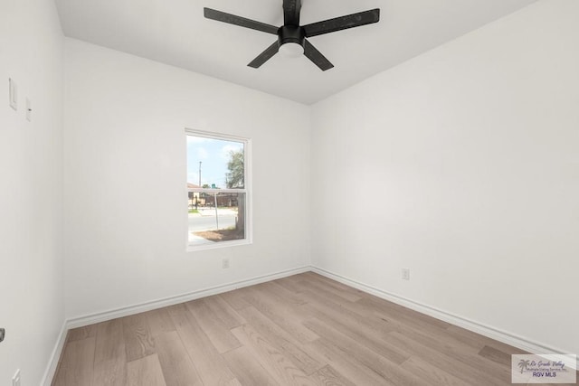 spare room featuring light wood-type flooring, ceiling fan, and baseboards