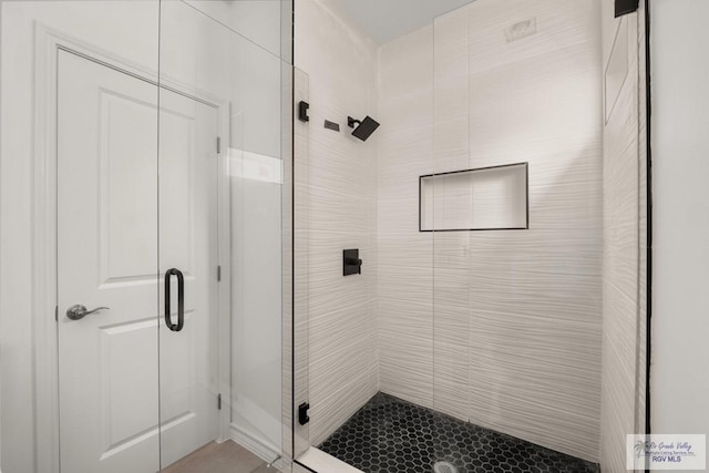 bathroom featuring a shower stall