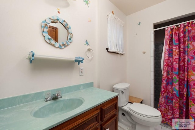 bathroom with walk in shower, vanity, and toilet