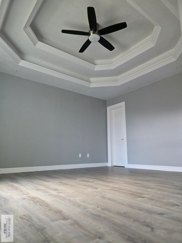 4116 Yoli Ln, Brownsville, TX 78521 - spare room with a tray ceiling, ornamental molding, wood finished floors, and ceiling fan