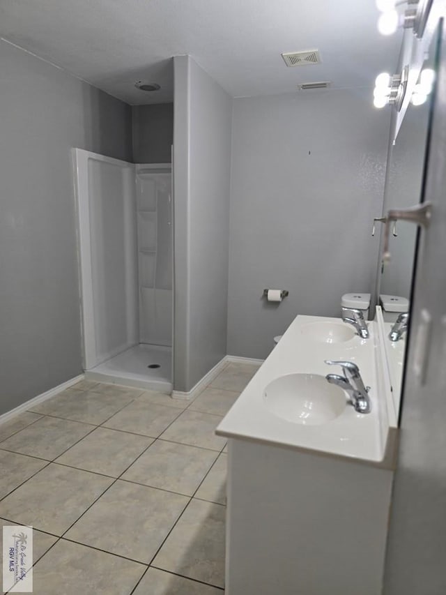 4116 Yoli Ln, Brownsville, TX 78521 - full bath featuring double vanity, tile patterned flooring, and a stall shower