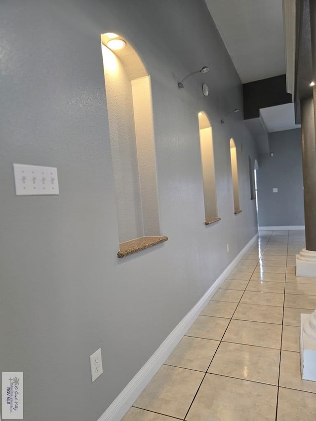 4116 Yoli Ln, Brownsville, TX 78521 - corridor with arched walkways and light tile patterned floors