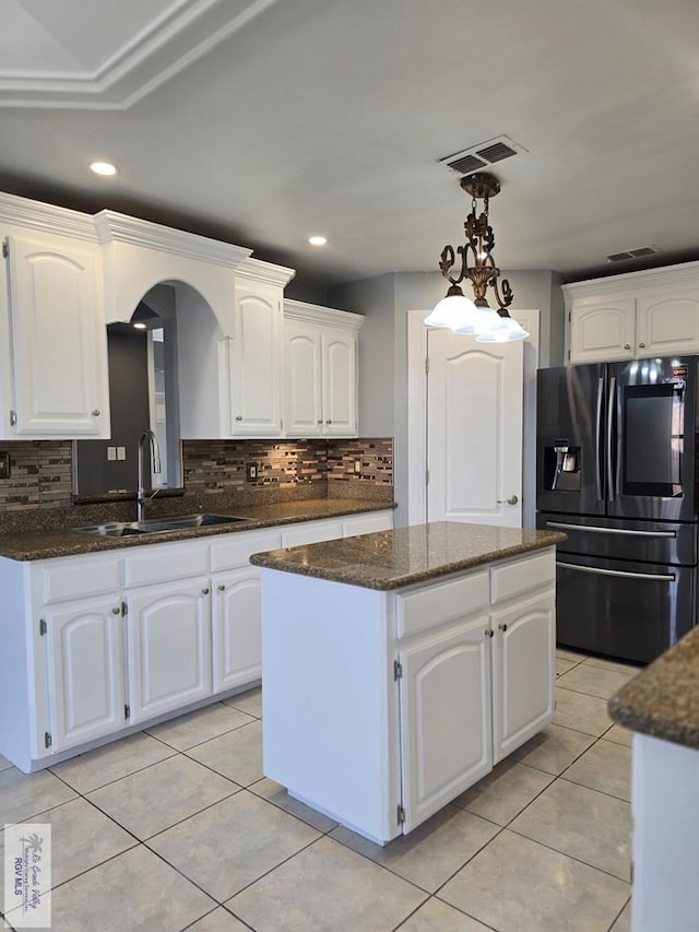 4116 Yoli Ln, Brownsville, TX 78521 - kitchen featuring fridge with ice dispenser, a center island, backsplash, dark stone counters, and recessed lighting