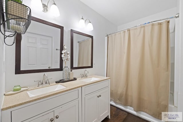 30202 Ratliff Rd, San Benito, TX 78586 - bathroom with shower / bath combo with shower curtain, wood finished floors, and double vanity