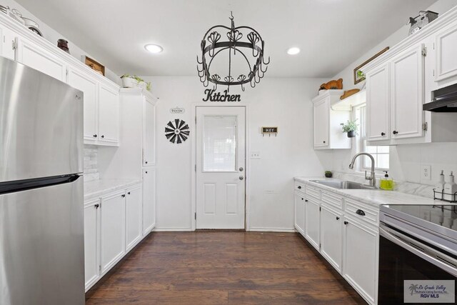 30202 Ratliff Rd, San Benito, TX 78586 - kitchen featuring appliances with stainless steel finishes, a sink, white cabinets, recessed lighting, and dark wood-style floors