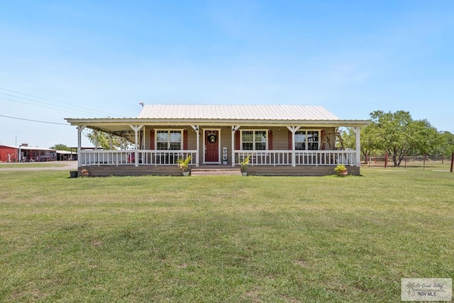 30202 Ratliff Rd, San Benito, TX 78586 - farmhouse-style home featuring a porch, a front lawn, and metal roof