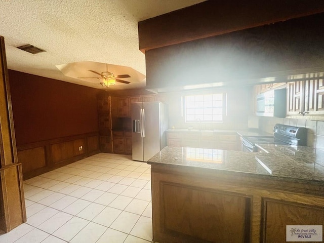 4407 Alejandro St, Mission, TX 78573 - kitchen featuring stainless steel fridge with ice dispenser, electric stove, a sink, a ceiling fan, and a peninsula