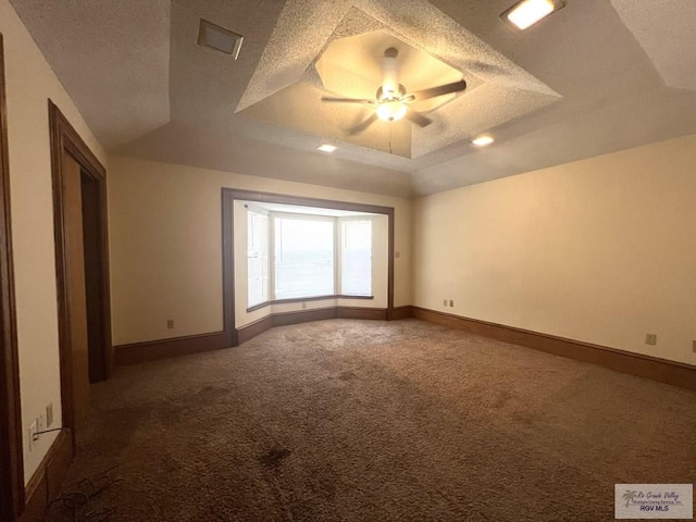 4407 Alejandro St, Mission, TX 78573 - unfurnished bedroom featuring carpet flooring, a tray ceiling, baseboards, a textured ceiling, and a ceiling fan