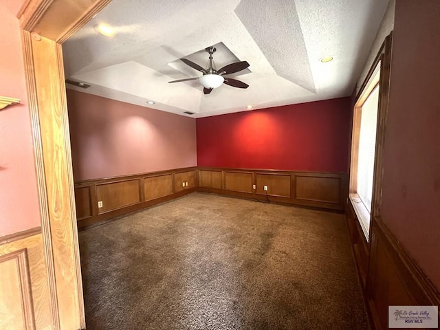 4407 Alejandro St, Mission, TX 78573 - unfurnished room with a raised ceiling, a ceiling fan, a textured ceiling, carpet floors, and a wainscoted wall
