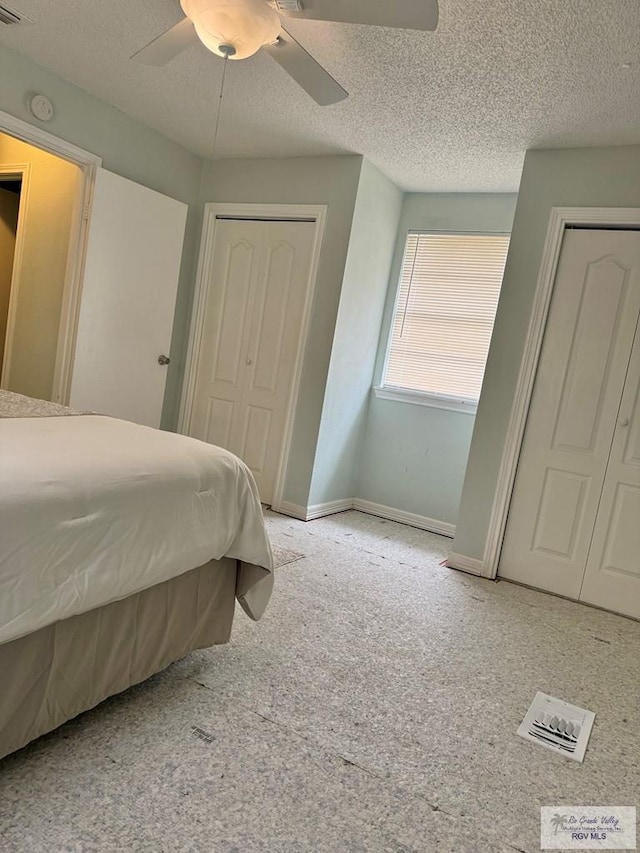 bedroom with ceiling fan, light carpet, and a textured ceiling