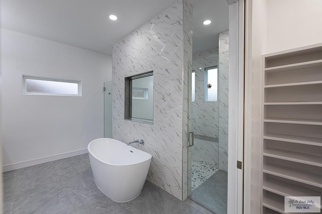 bathroom featuring shower with separate bathtub