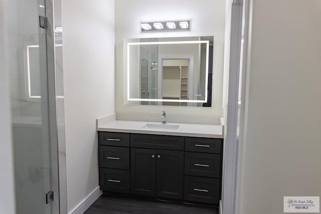 bathroom featuring vanity and an enclosed shower