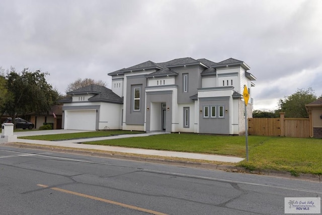 view of front of home featuring a garage and a front yard