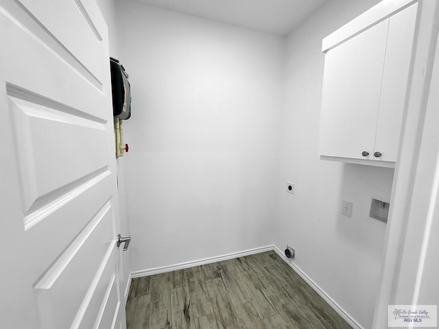 laundry area featuring cabinets, dark wood-type flooring, and hookup for an electric dryer