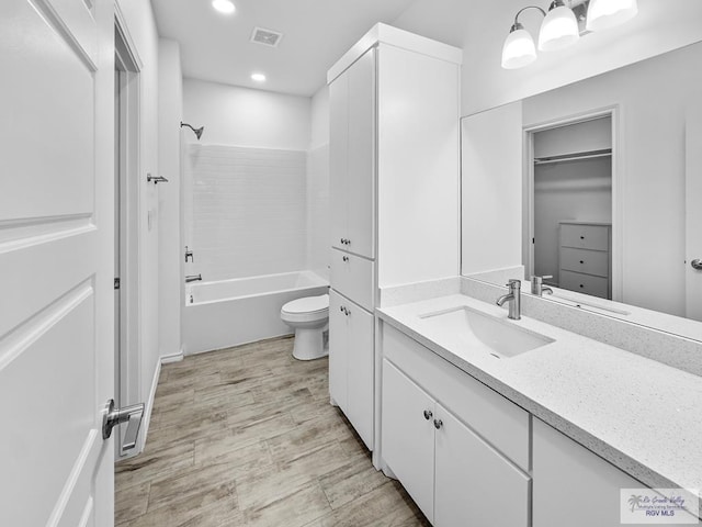 full bathroom with shower / tub combination, vanity, and toilet