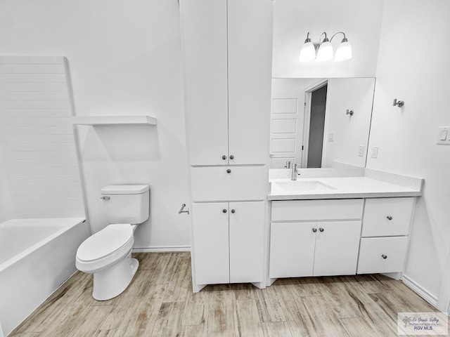 full bathroom featuring hardwood / wood-style flooring, vanity, toilet, and tub / shower combination