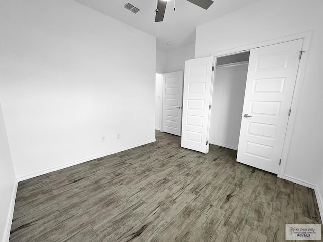 unfurnished bedroom with a closet, ceiling fan, and dark hardwood / wood-style flooring