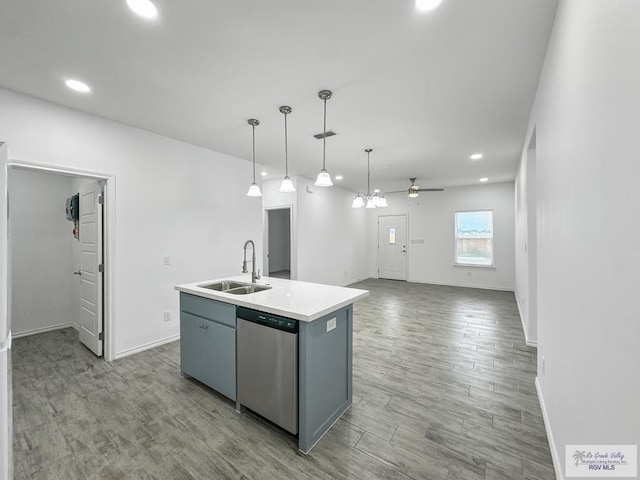 kitchen featuring dishwasher, a center island with sink, sink, ceiling fan, and decorative light fixtures