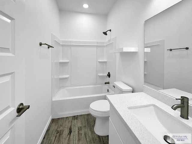 full bathroom featuring hardwood / wood-style floors, vanity, toilet, and shower / bath combination