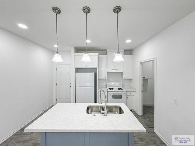 kitchen featuring sink, an island with sink, decorative light fixtures, and white appliances