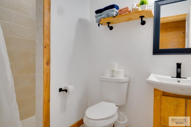 bathroom with vanity, toilet, and walk in shower