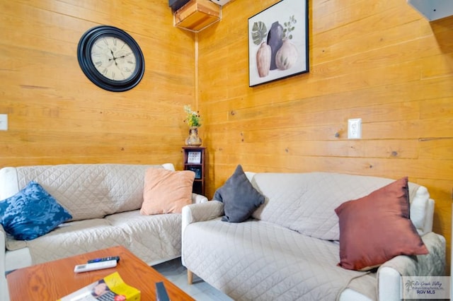 living room with wood walls