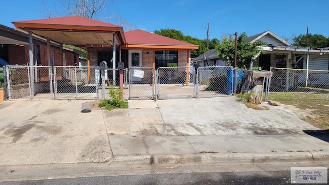 view of front of home featuring brick siding, fence, and a gate