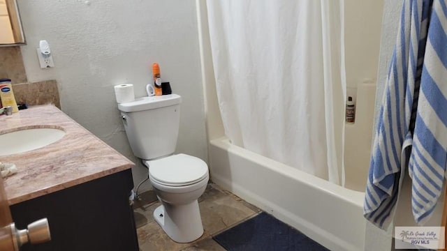 full bathroom with shower / bath combination with curtain, a textured wall, vanity, and toilet