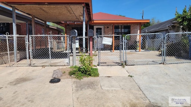 view of front facade featuring a gate and brick siding