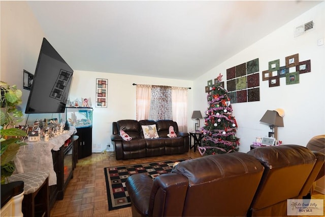 living room featuring lofted ceiling and parquet floors