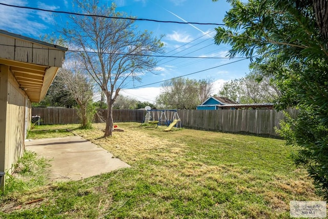 view of yard with a playground and a patio