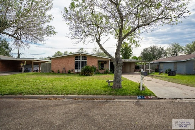 ranch-style house with a carport and a front yard